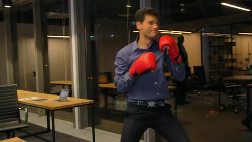 Man Boxing in Modern Office at Night