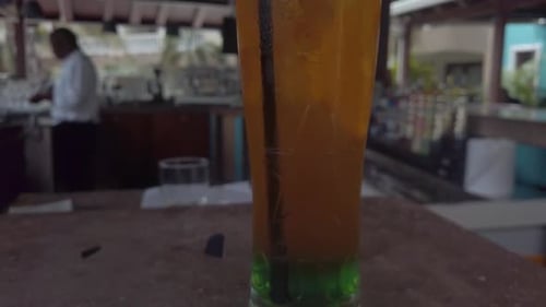 Revealing a cocktail.
Its on the bar.
Ready to be tasted.