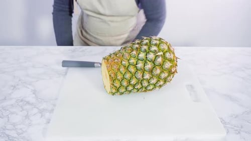 Cutting a Fresh Pineapple on a Cutting Board