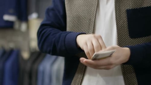 Male Customer Paying with Cash at Checkout