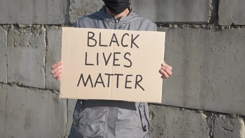 Person Holds Black Lives Matter Sign