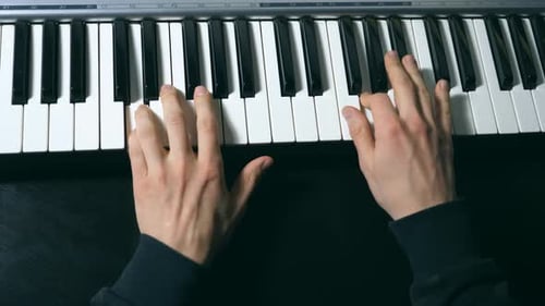 Hands of Male Musician Playing at Synthesizer