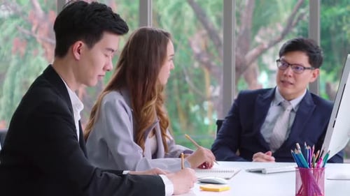 Business Meeting With Colleagues at a Desk