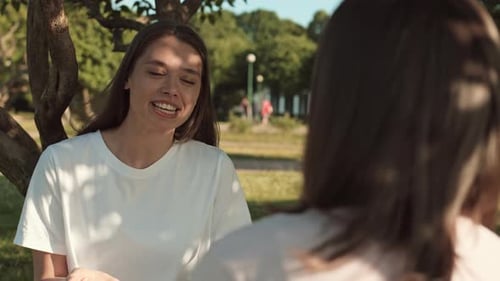 Woman Chatting with Friend in Park