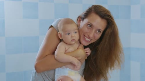 Loving Tender Young Mum Holding Adorable Cute Baby Girl Daughter Kissing Small Kid