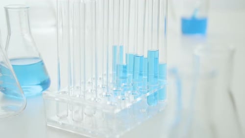 Laboratory Glassware with Blue Liquid in Test Tubes