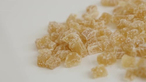 Slow pan over crystallized Zingiber officinale cubes on pile 4K 2160p 30fps UltraHD footage - Piece