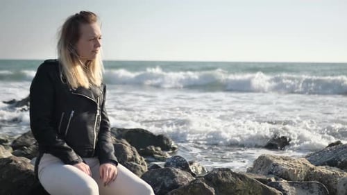 Woman Look at the Sea and Sit on the Beach