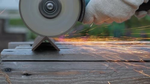 Worker in Gloves Use Angle Grinder