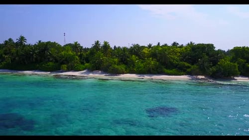 Aerial top down nature of tranquil seashore beach holiday by clear lagoon and white sandy background