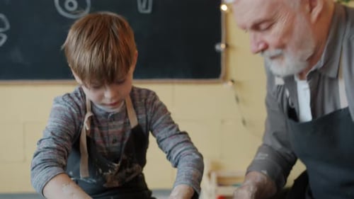 Boy Learning Pottery from an Older Man