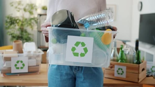 Woman Holding Container Full of Recyclable Plastics