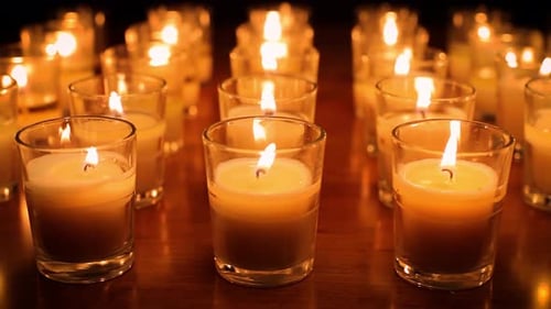 Rows of candles in a church or temple.
