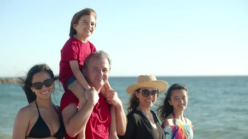 Medium Shot of Happy Family Standing in Line on Beach