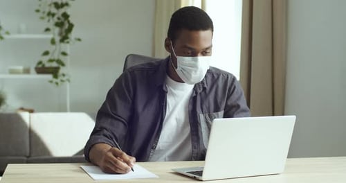 Young Adult Working from Home Wearing Face Mask