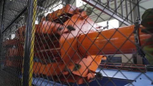 Orange Industrial Machine Spinning Inside Factory