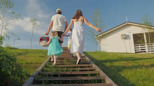 Happy Family with Children Go on a Picnic Together Outside the City