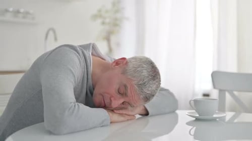 Exhausted Senior Old Man Having Nap on Dining Table