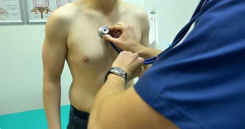 Clinic Physician Examining Man By Stethoscope