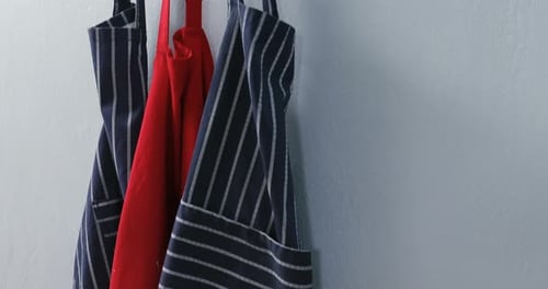 Colorful Aprons Hanging on a Wooden Rack
