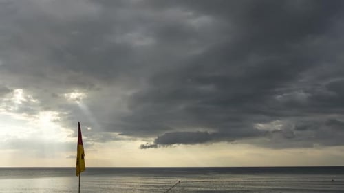 Lifeguard Flag Waving on Cloudy Beach Day