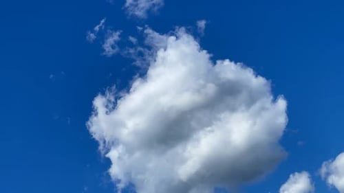 Fluffy White Clouds Against a Clear Blue Sky