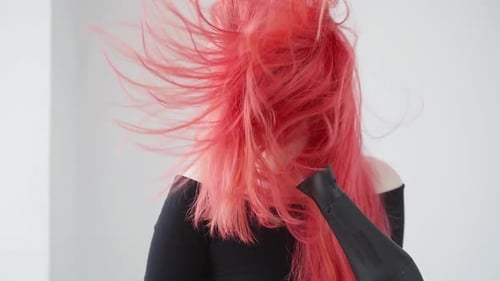 Young Woman Drying Long Vibrant Hair
