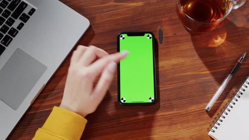 Woman Using Smartphone with Green Screen Top View