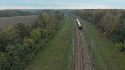 Freight Train Moving Through Rural Landscape Aerial View