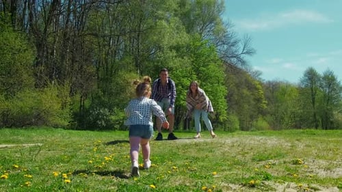 Happy Family Resting in Nature Near the Forest