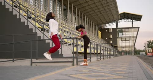 Black Femake Friends Exercise Together at Stadium