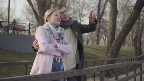 Couple on a Bridge in the City Park