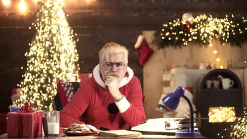 Portrait of Tired Santa Claus at Home Near Christmas Tree. New Year Holiday.
