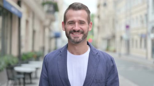 Outdoor Portrait of Man Looking at Camera While Standing in Street