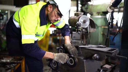 Factory Worker is Setting Up CNC Lathe Machine