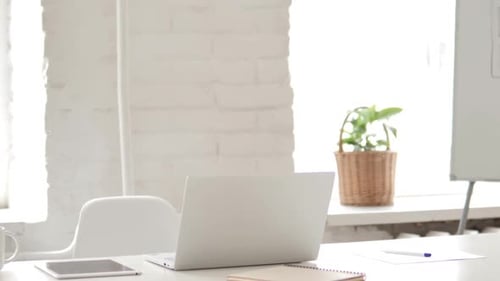 Empty Office with Laptop on Desk