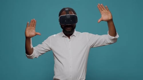 Man Gesturing While Wearing VR Headset