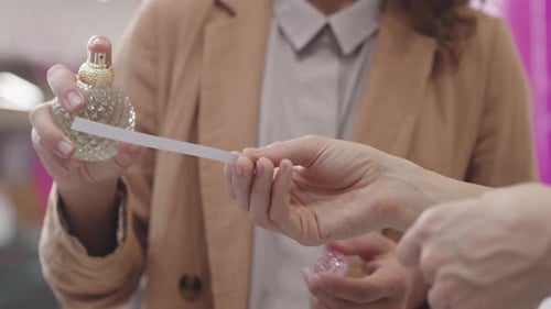 Adult Tries Perfume in Stylish Store