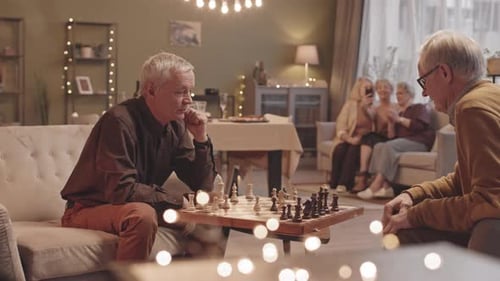 Seniors Enjoying Chess Game in Cozy Home