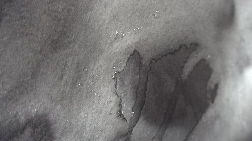 Spreading Dark Watercolor on Textured Paper
