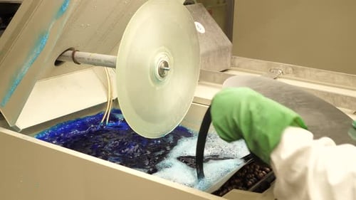 Machine Polishing Object with Blue Liquid in Factory