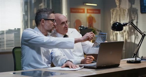 Doctors Collaborating Examining X-ray in Office
