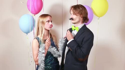 Young woman and man in photo booth
