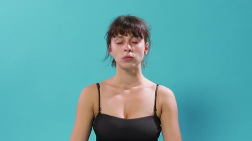Woman Meditating Peacefully with Eyes Closed