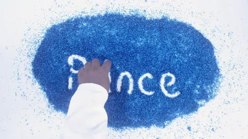 Hand Writes Prince in Blue Particles