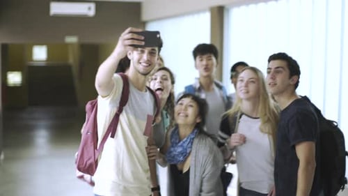 Enthusiastic Students Take Selfie in School Hallway