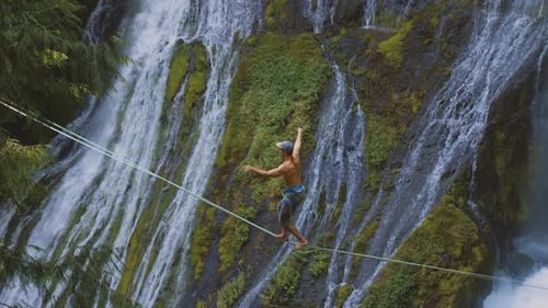 Fit Man High-lining Over A Waterfall