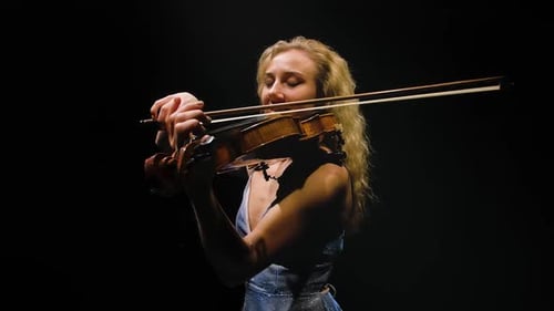 Woman Playing Violin in the Spotlight