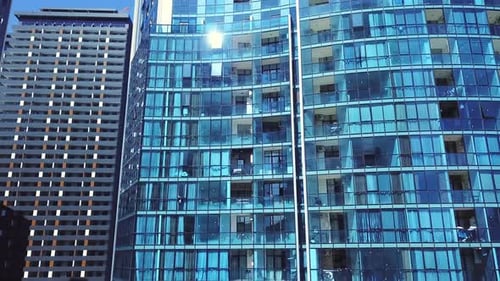 View of high-rise glass building and dark steel window system against