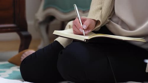 Woman Writing in Journal with Silver Pen